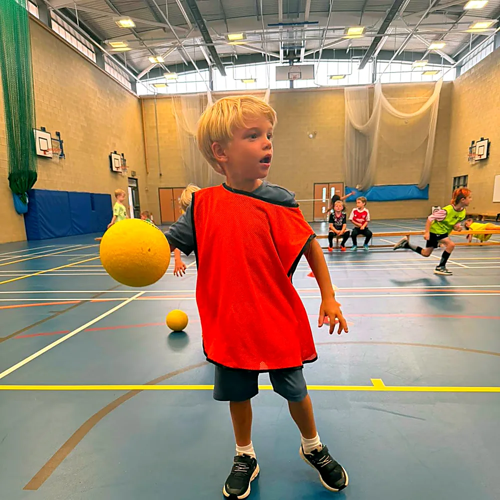 A boy throwing a dodgeball at an after-school multi-sport club