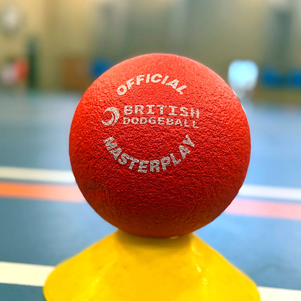 A British Dodgeball ball resting on a yellow marker cone